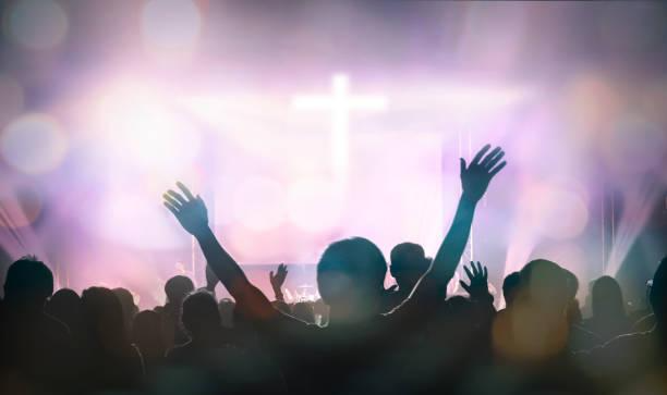 Group in worship with raised arms